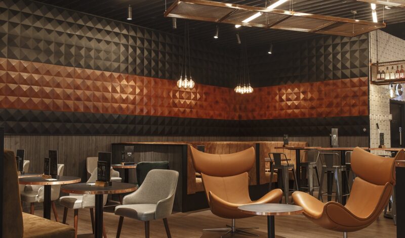 Seating area with 3D pyramid wall panelling at The Edit Bar designed for Vue