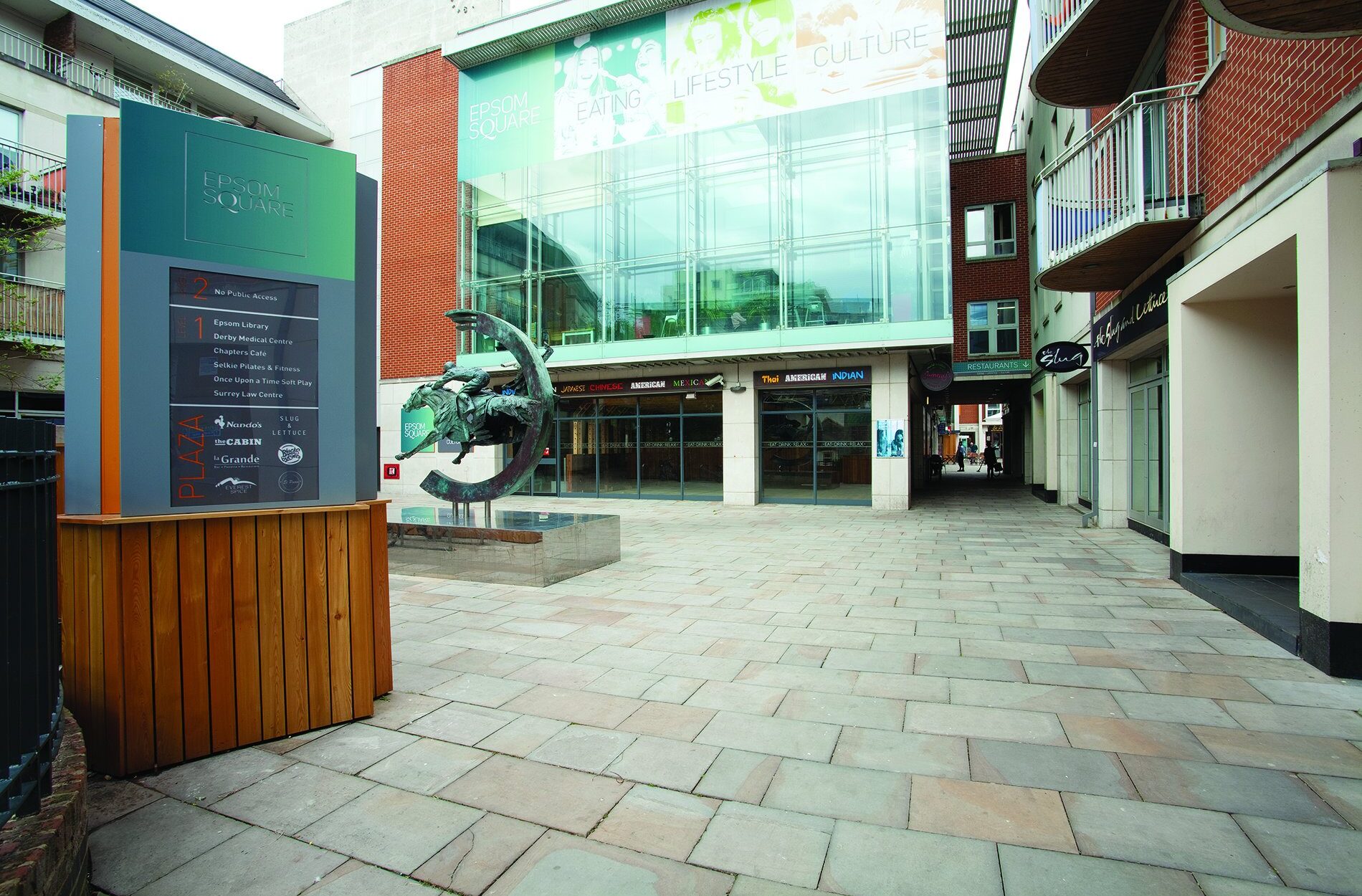 Exterior of Epsom Square entrance with horse riding sculpture and signage Beyond London Eposom Square Shopping Centre Retail Design Asset Enhancement Brand Identity Signage & Wayfinding Customer Experience design