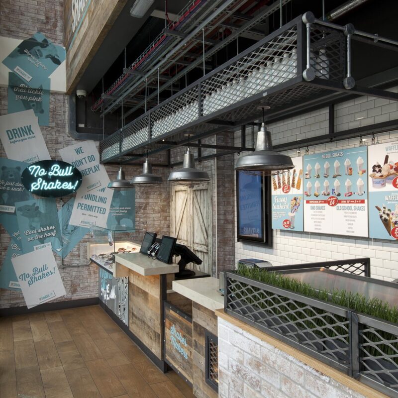Interior design of the shake lab store with counter and wall of graphics designed by beyond london Beyond London Shake Lab Brand Identity and guidelines Logo DesignTone of Voice Retail Design Retail Design guidelines