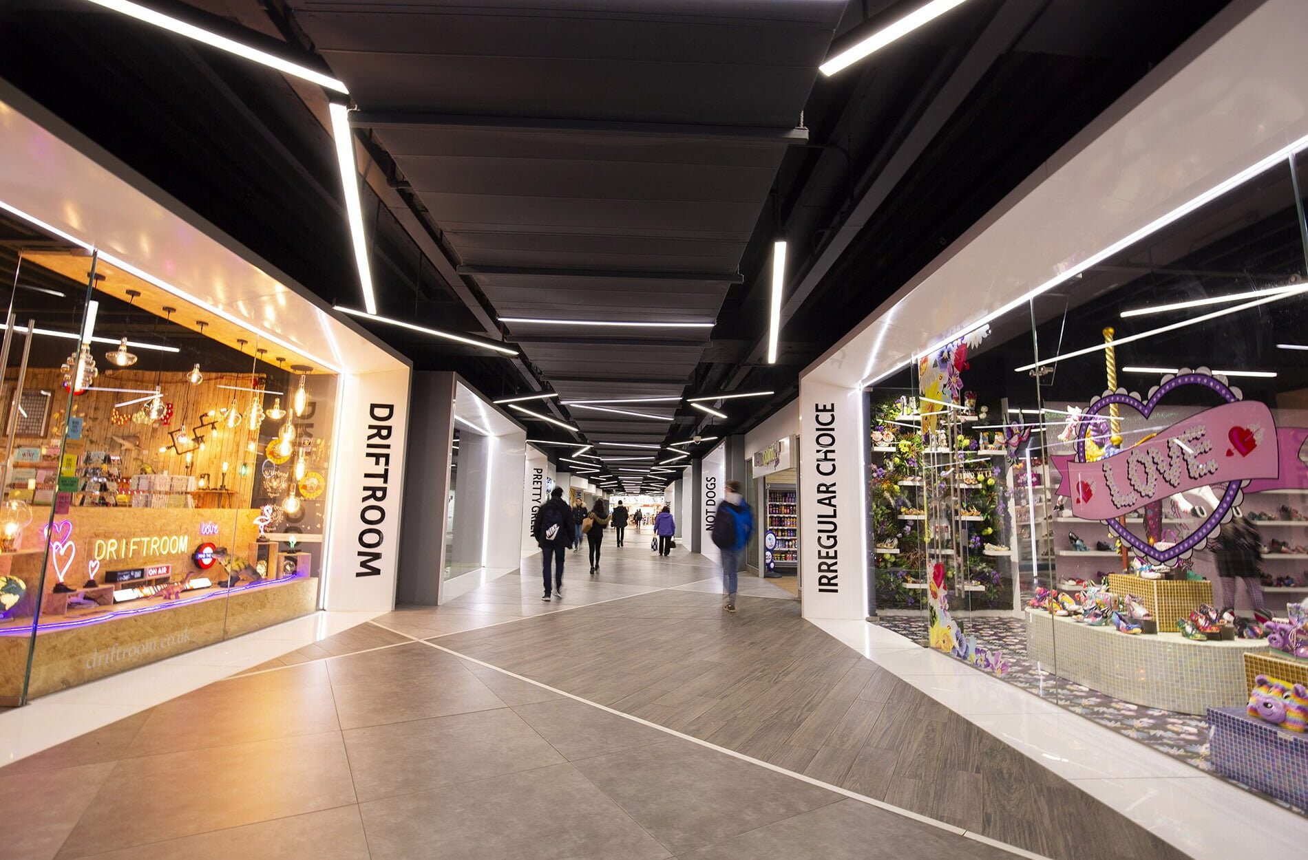 central walkway of link street with quirky brands in units either side Beyond London Link Street BrirminghamCustomer Experience design Interior Design Retail Design Signage & Wayfinding