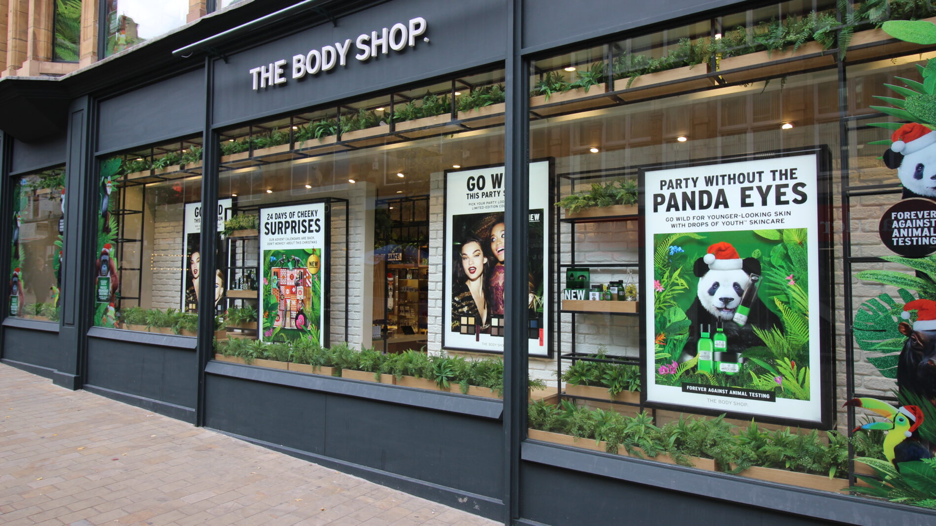 exterior of the body shop store with 'party without the panda eyes' window display Beyond London The Body Shop - Retail strategy and Retail Design Store Design Point of Sale Design Retail guidelines Rollout Customer Experience design